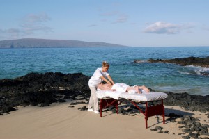 Woman receiving massage at coast